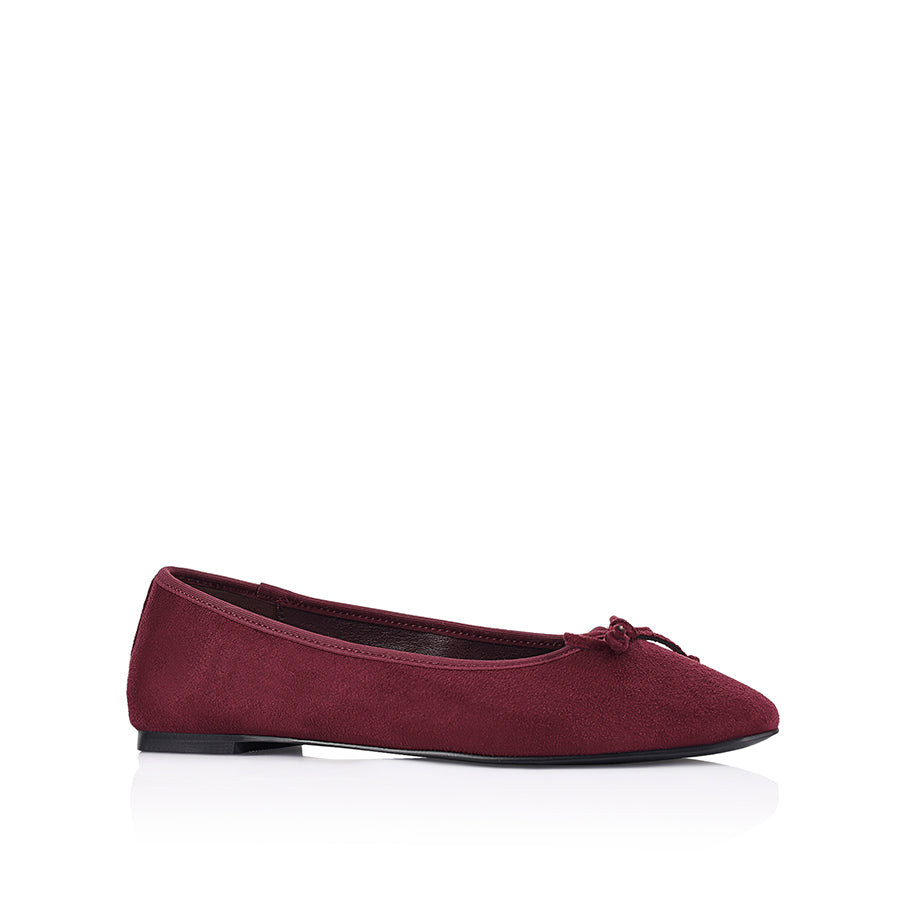 Burgundy microsuede ballet flats with a black heel and small bow