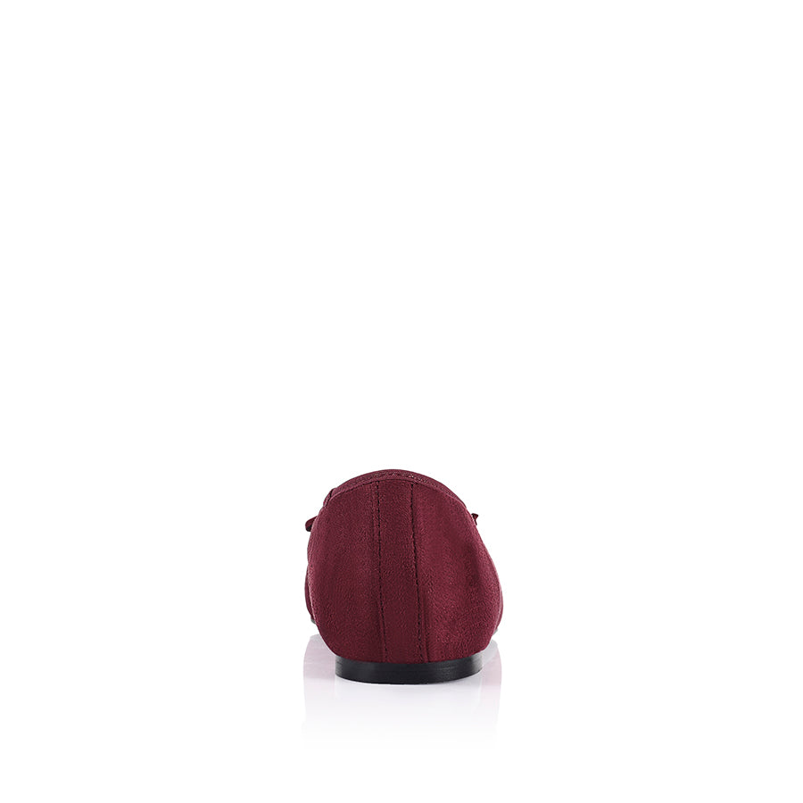 Burgundy microsuede ballet flats with a black heel and small bow