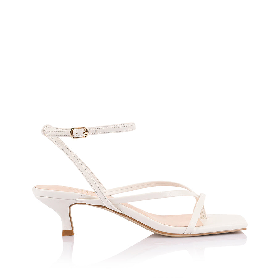 Women's low kitten heel, strappy thong style with adjustable ankle strap in smooth white