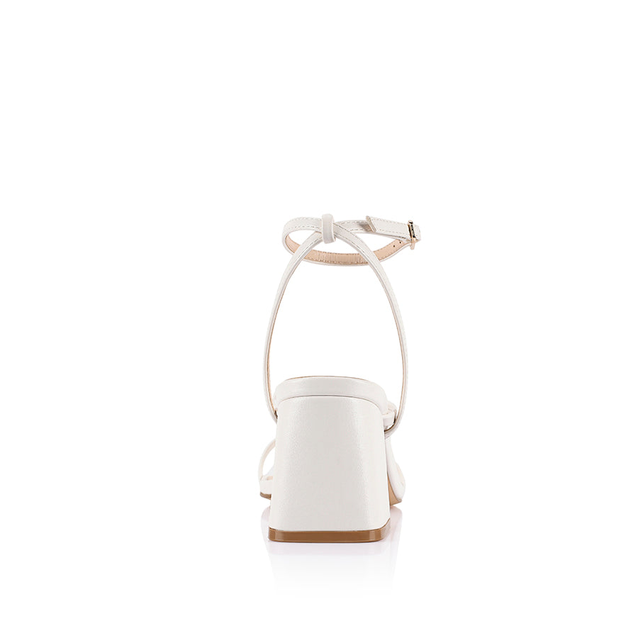 White high-heeled sandal on a block heel with a square toe shape