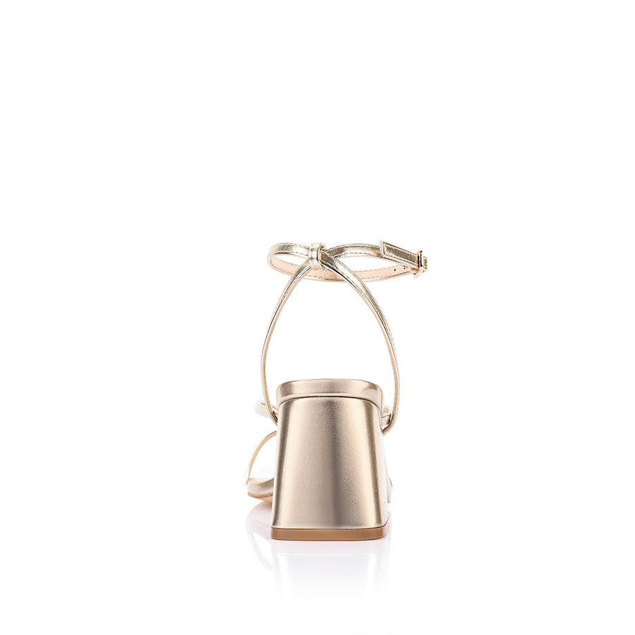 Gold high-heeled sandal on a block heel with a square toe shape
