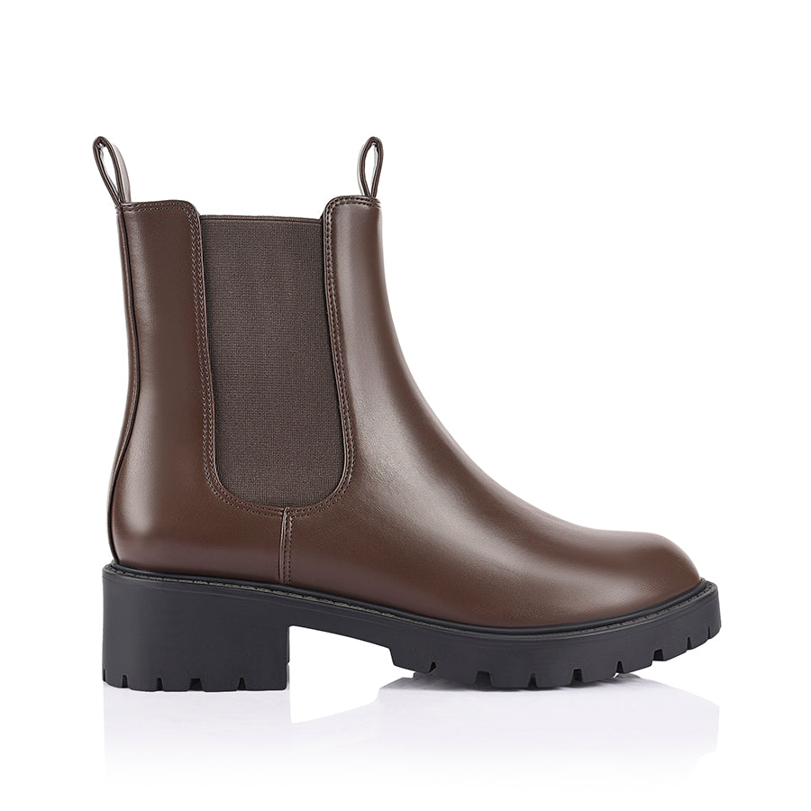 Brown Chelsea boot with a black sole with a rounded toe shape