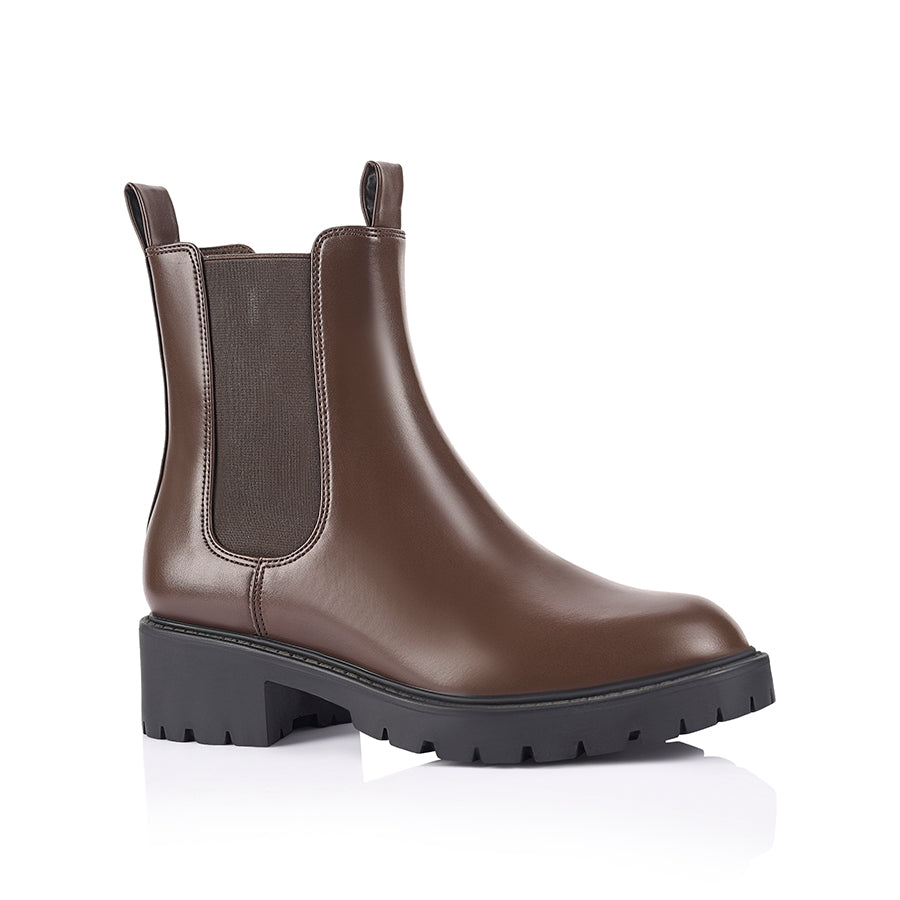 Brown Chelsea boot with a black sole with a rounded toe shape