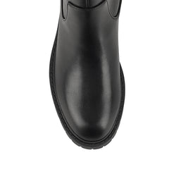 Black knee-high boot on a a chunky sole