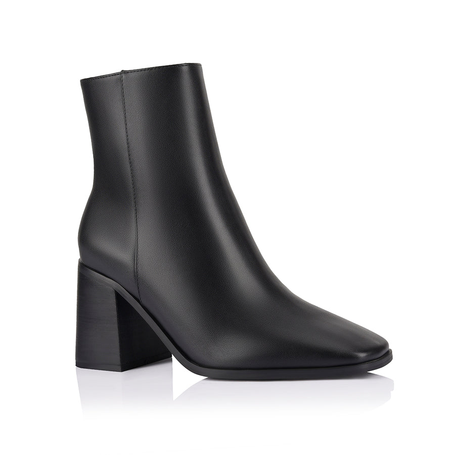 Black ankle boots with a block heel, zip closure and square toe shape