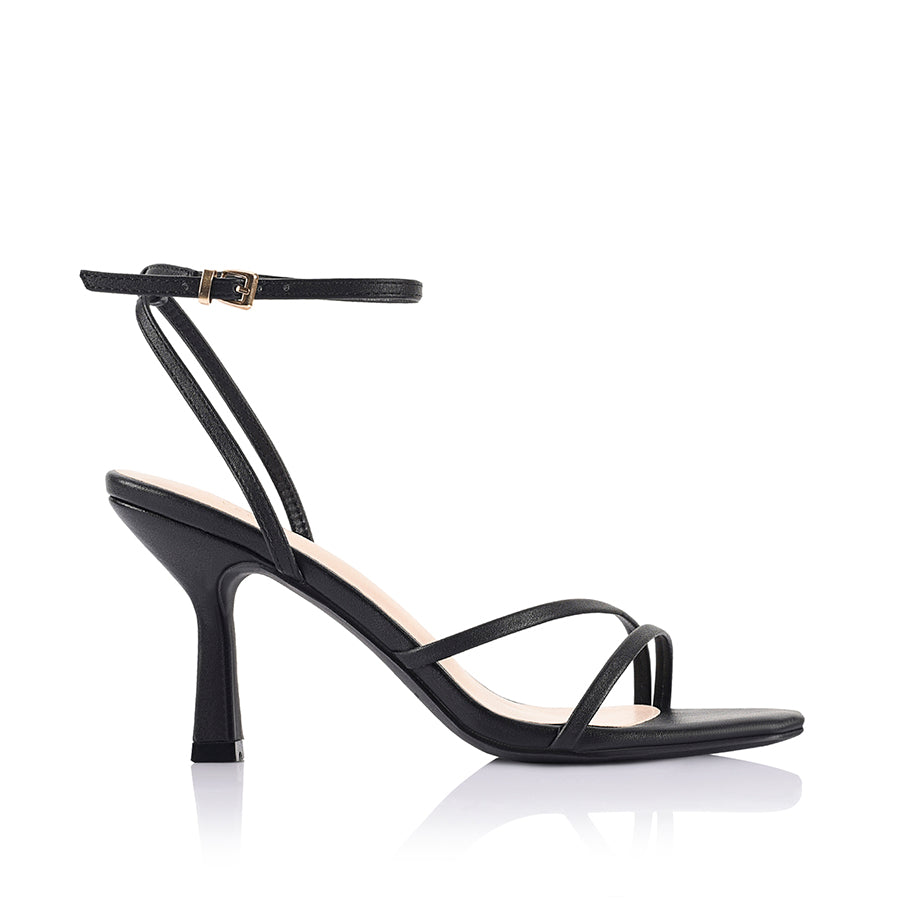 Black high-heeled sandal with thin straps that fasten with a gold buckle