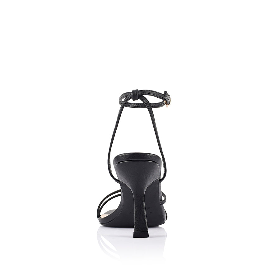 Black high-heeled sandal with thin straps that fasten with a gold buckle