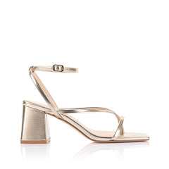 Gold high-heeled sandal on a block heel with a square toe shape