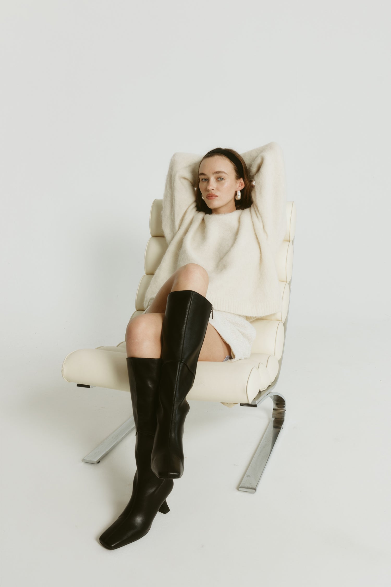 Women's vegan black smooth knee high boot with chiseled toe and flared stiletto heel